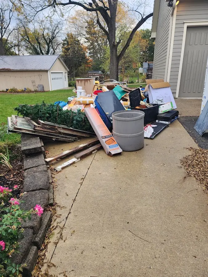 Dumpster being loaded with debris for Demolition Dumpster Rental in East Hills